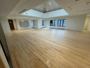 A big hall with hardwood work and windows