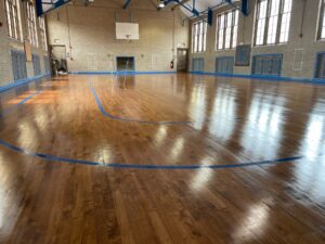 A wooden floor of a basketball court clean and shinning