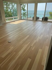 A wooden floor of a house in front of the sea