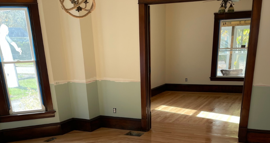 Custom hardwood floor with natural wood grain and smooth finish, reflecting sunlight in a residential interior.